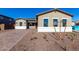 Front view of a single-story house with a brown garage door and landscaped front yard at 16348 W Avenida Del Sol --, Surprise, AZ 85387