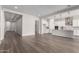 Open concept living area with wood-look flooring and view of the kitchen at 16348 W Avenida Del Sol --, Surprise, AZ 85387