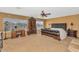 Luxurious main bedroom with a large bed, built-in cabinetry, and a ceiling fan at 9558 W Gambit Trl, Peoria, AZ 85383