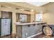 Wet bar with granite countertop, ample storage, and a safe at 9558 W Gambit Trl, Peoria, AZ 85383
