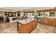 Open kitchen with granite island and breakfast nook at 9558 W Gambit Trl, Peoria, AZ 85383