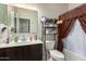 Small bathroom with toilet, shower and shelving unit at 285 S Espada Trl, Casa Grande, AZ 85194