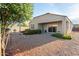 Backyard with gravel, flowers, and a view of the house's back at 285 S Espada Trl, Casa Grande, AZ 85194