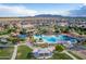 Aerial view of community pool with water features, playground, and shaded seating areas at 285 S Espada Trl, Casa Grande, AZ 85194