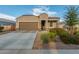 One-story home with brown garage door and landscaping at 285 S Espada Trl, Casa Grande, AZ 85194