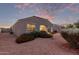 Spacious backyard with gravel landscaping, featuring red flowers and a bird bath at 285 S Espada Trl, Casa Grande, AZ 85194