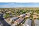 Aerial view of homes in a neighborhood, with a park visible in the distance at 285 S Espada Trl, Casa Grande, AZ 85194