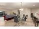Bright dining area with a glass table and six chairs, overlooking the living room at 285 S Espada Trl, Casa Grande, AZ 85194