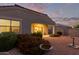 Backyard view at dusk showcasing a patio and blooming flowers at 285 S Espada Trl, Casa Grande, AZ 85194