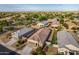 Aerial view of houses in a residential neighborhood, showcasing backyard and community at 285 S Espada Trl, Casa Grande, AZ 85194