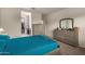 Spacious bedroom with teal bedding and large dresser at 285 S Espada Trl, Casa Grande, AZ 85194