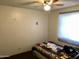 Second bedroom with a ceiling fan and large window at 605 N Lesueur Cir, Mesa, AZ 85203