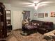 Living room with dark brown couches and a coffee table at 605 N Lesueur Cir, Mesa, AZ 85203