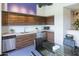 Modern kitchen with dark wood cabinets and glass table at 535 W Thomas Rd # 503, Phoenix, AZ 85013