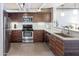 Modern kitchen with dark wood cabinets and stainless steel appliances at 535 W Thomas Rd # 503, Phoenix, AZ 85013