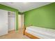 Small bedroom with a twin-size bed and green walls at 8690 S 253Rd Ave, Buckeye, AZ 85326