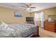 Bedroom with a bed, dresser, and ceiling fan at 8690 S 253Rd Ave, Buckeye, AZ 85326