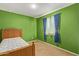 Small bedroom with a twin-size bed and green walls at 8690 S 253Rd Ave, Buckeye, AZ 85326