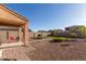 Backyard with covered patio, artificial turf and gravel at 8690 S 253Rd Ave, Buckeye, AZ 85326