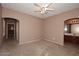 Bedroom with ceiling fan and access to bathroom at 27762 N 96Th Dr, Peoria, AZ 85383