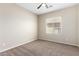 Well-lit bedroom with window and ceiling fan at 23392 S 209Th Pl, Queen Creek, AZ 85142