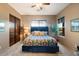 Bedroom with blue headboard bed, ceiling fan, and plenty of natural light at 16414 E Pinnacle Vista Dr, Scottsdale, AZ 85262