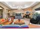 Living room with a stone fireplace, hardwood floors, and comfortable seating at 16414 E Pinnacle Vista Dr, Scottsdale, AZ 85262