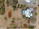 An aerial view showcasing a house, pool, and various outbuildings on a spacious desert lot at 16414 E Pinnacle Vista Dr, Scottsdale, AZ 85262