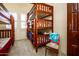 bedroom with a wooden bunk bed and window at 9233 S Krista E Dr, Goodyear, AZ 85338