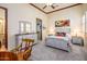 Bright bedroom with a queen-size bed, dresser, and desk at 9233 S Krista E Dr, Goodyear, AZ 85338