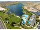 Community lake, pool, and park with palm trees and mountain backdrop at 9233 S Krista E Dr, Goodyear, AZ 85338