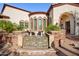Water feature in front of a luxury home's entrance at 9233 S Krista E Dr, Goodyear, AZ 85338