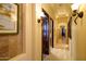 Long hallway with warm lighting and access to multiple rooms at 9233 S Krista E Dr, Goodyear, AZ 85338