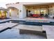 Relaxing pool and spa with fire pit and ample seating; perfect for entertaining at 9233 S Krista E Dr, Goodyear, AZ 85338