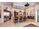 Gourmet kitchen with granite counters, island, stainless steel appliances, and custom cabinetry at 9233 S Krista E Dr, Goodyear, AZ 85338