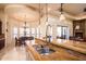 Kitchen island with double sink and breakfast bar seating at 9233 S Krista E Dr, Goodyear, AZ 85338