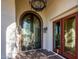 Ornate double doors and arched entryway with hanging chandelier at 9233 S Krista E Dr, Goodyear, AZ 85338