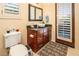 Bathroom with toilet, sink, and door to outside at 9233 S Krista E Dr, Goodyear, AZ 85338