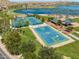 Community tennis and basketball courts near a lake at 9233 S Krista E Dr, Goodyear, AZ 85338