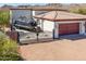 Luxury home exterior with gated entry and mountain views at 9233 S Krista E Dr, Goodyear, AZ 85338