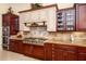 Spacious kitchen with granite countertops and a gas cooktop at 9233 S Krista E Dr, Goodyear, AZ 85338
