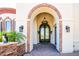 Elegant entryway with arched double doors, chandelier, and stone accents at 9233 S Krista E Dr, Goodyear, AZ 85338
