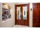 Double doors with etched glass and ornate wood detailing at 9233 S Krista E Dr, Goodyear, AZ 85338