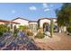 Front view of a large home with a water feature and landscaping at 9233 S Krista E Dr, Goodyear, AZ 85338
