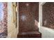 Large walk-in shower with mosaic tile and built-in seating at 9233 S Krista E Dr, Goodyear, AZ 85338