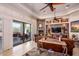 Living room with stone fireplace, patio access, and seating area at 9233 S Krista E Dr, Goodyear, AZ 85338