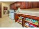 Laundry room with washer, dryer, and storage shelves at 9233 S Krista E Dr, Goodyear, AZ 85338