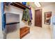 Laundry room with mini fridge, hanging space, and storage at 9233 S Krista E Dr, Goodyear, AZ 85338