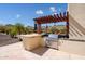Stainless steel grill and outdoor kitchen with pergola; mountain views at 9233 S Krista E Dr, Goodyear, AZ 85338