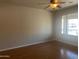 Living room with hardwood floors, large window, and ceiling fan at 4327 E San Gabriel Ave, Phoenix, AZ 85044